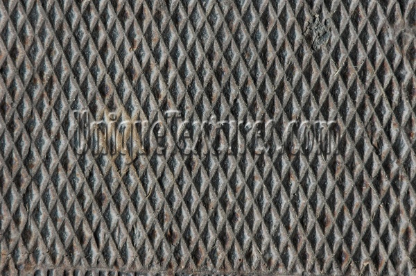 manhole diamonds pattern shadow rusty industrial metal dark brown gray  