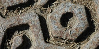 manhole hexagon pattern shadow dirty weathered industrial metal dark brown