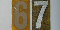sign numerical cracked/chipped weathered scratched mech/elec metal paper multicolored