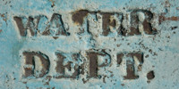 blue paint metal industrial bleached scratched weathered textual sign manhole