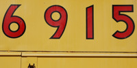 yellow red vibrant paint metal industrial numerical sign